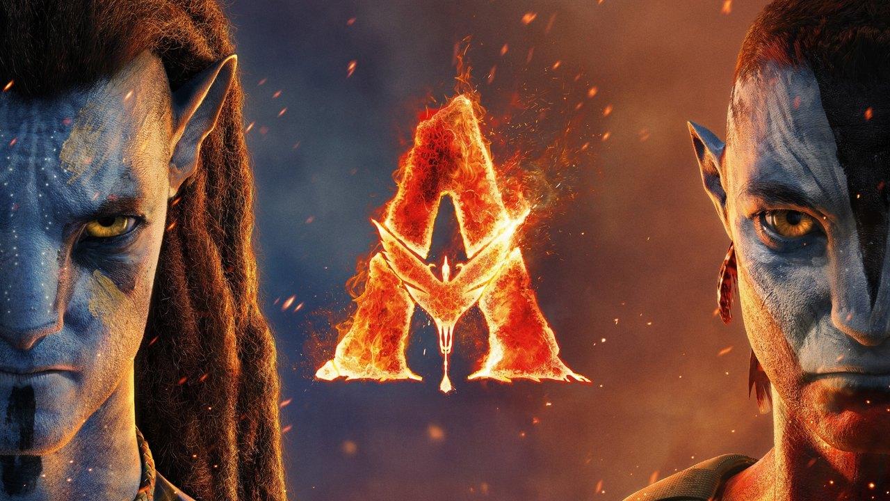 Large blue Na’vi faces occupy opposite edges of the frame around a glowing fire-colored emblem.