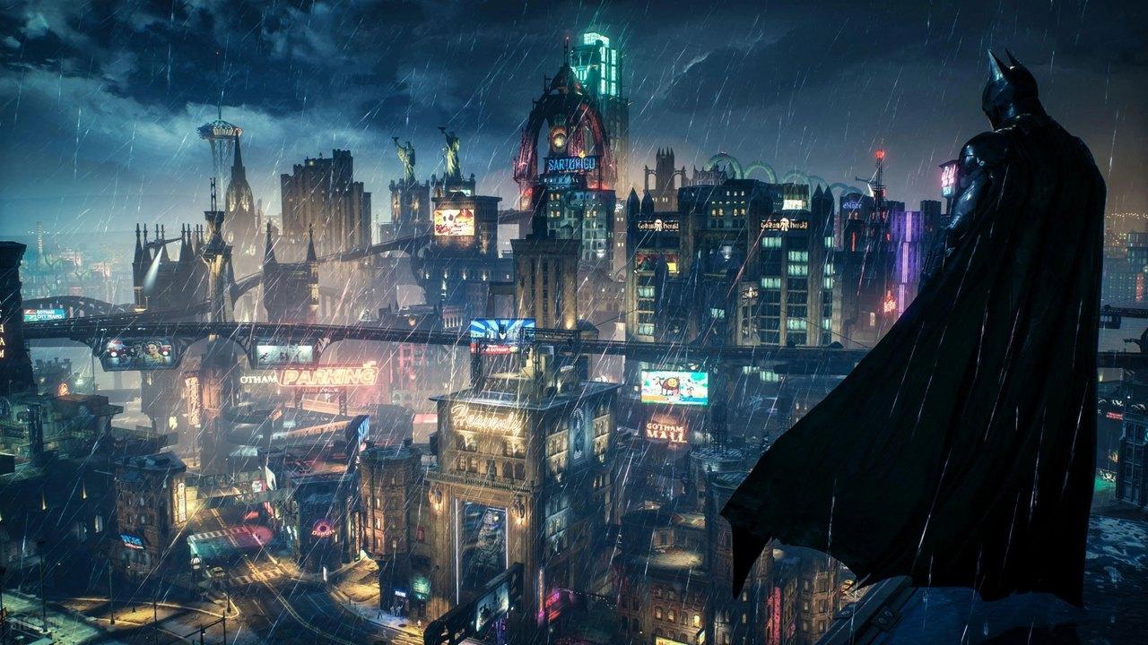 Batman stands near the right edge above a dense blue Gotham skyline filled with lit windows.