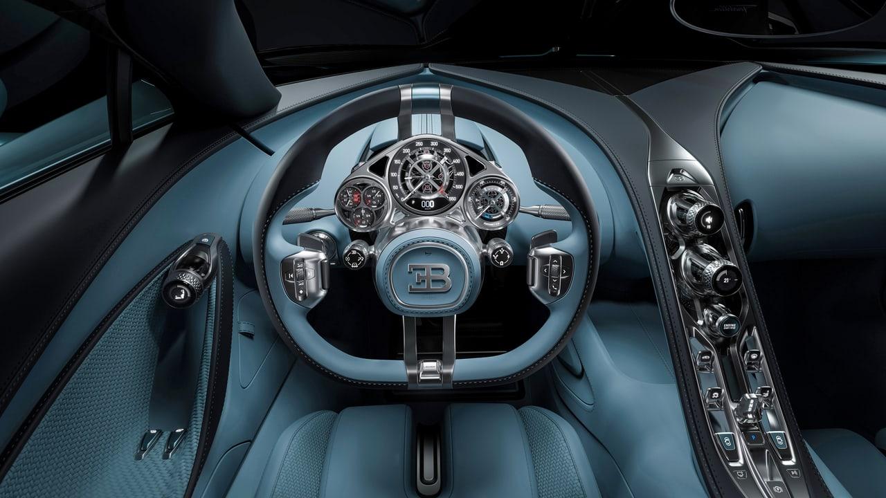 The Tourbillon cockpit spreads across the image with round instruments, a sculpted wheel and a narrow center console. Dark blue trim follows the cabin's flowing lines. Source: 4kwallpapers.com. Original artist not identified by the source page.
