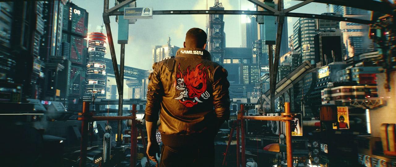 V looks across a dense city from behind a balcony rail in muted daylight. Signs, towers and elevated infrastructure crowd both edges. Source: 4kwallpapers.com. Original artist not identified by the source page.