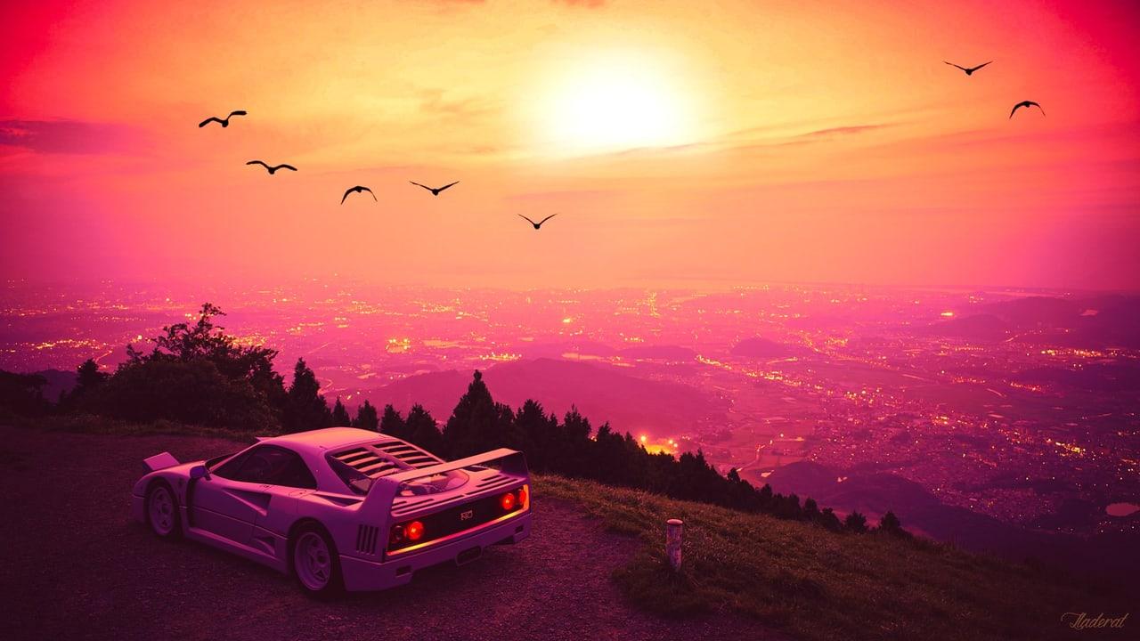 A Ferrari F40 overlooks a city from a hillside beneath a glowing pink-orange sunset and small bird silhouettes.