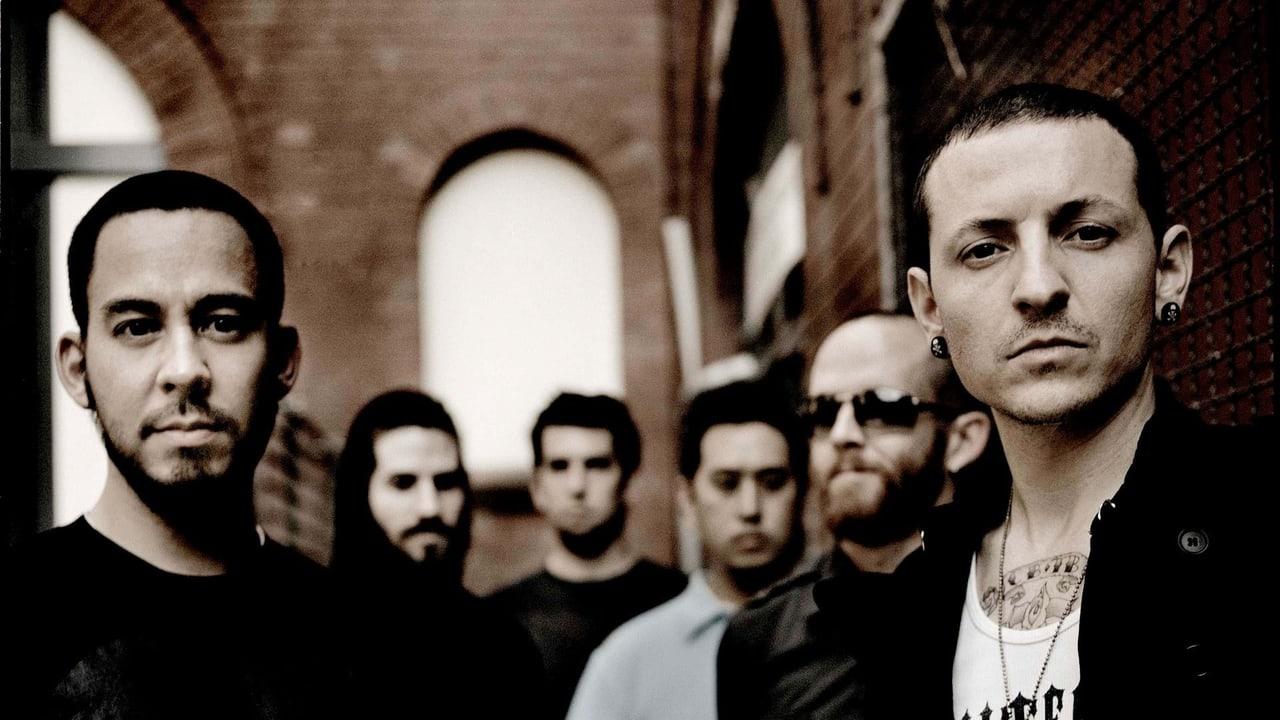 The historic Chester Bennington-era lineup stands in a brick passage beneath tall arches. The two outer portraits anchor the sepia group photograph. Source: satanavi on Wallpapers.com. Original artist not identified by the page.