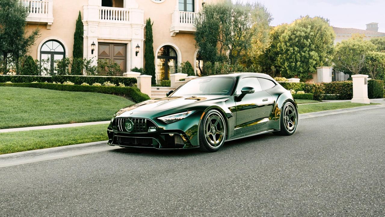A modified green AMG GT coupe sits beside a landscaped villa. Cream architecture, trees and hedges extend across the entire streetside setting.