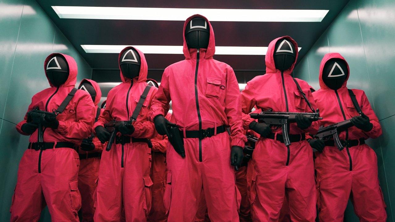 Pink-uniformed masked guards stand across a teal industrial corridor.