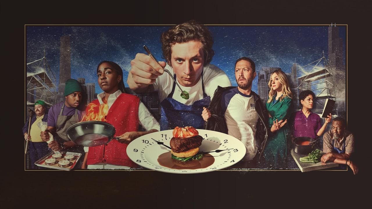 Carmy leans over a plated dish while the restaurant team surrounds him in a warm, framed composition. Kitchen equipment and colleagues continue to the outer margins. Source: Alpha Coders, discovered by Jesus Avila.